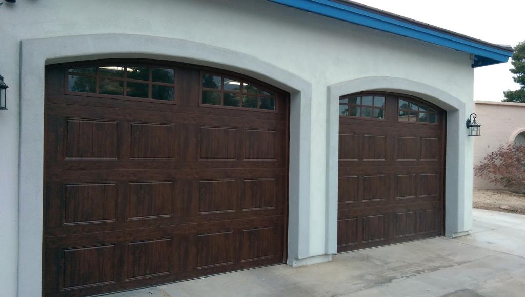 Two dark walnut wood-look garage doors installed on Arizona home